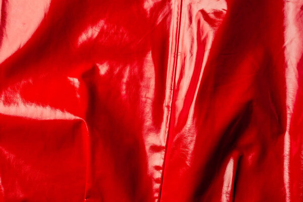 top view of red leather shiny textile as background 