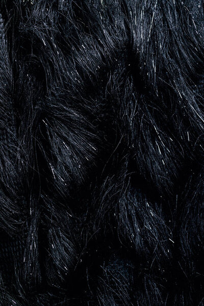 top view of furry black textile as background 