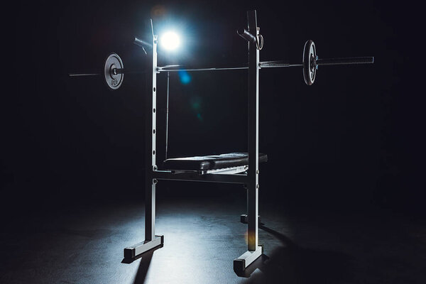 close up view of barbell at gym, black background 