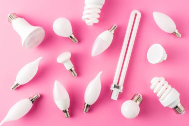top view of various types of light bulbs on pink   clipart