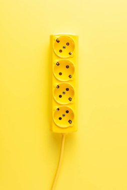 close-up view of bright yellow socket outlet on yellow background clipart