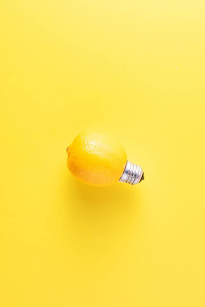 close-up view of light bulb made of lemon on yellow background    