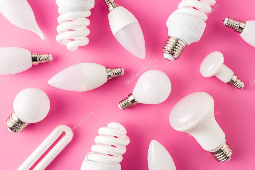 top view of various light bulbs on pink background 