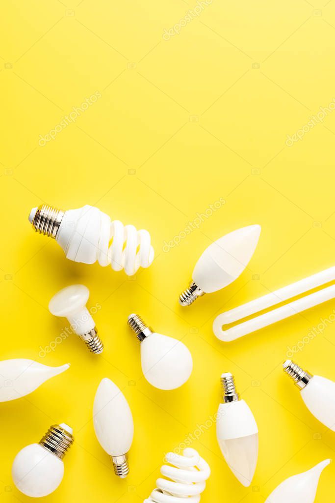 top view of various types of lamps on yellow background  