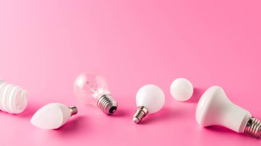 close-up view of various light bulbs on pink, energy concept clipart