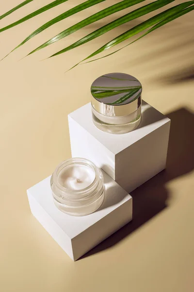 Close View Palm Leaf Body Creams Glass Jars White Cubes — Stock Photo, Image