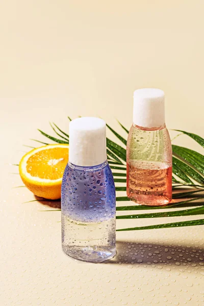 Close View Micellar Water Bottles Green Palm Leaf Orange Half — Stock Photo, Image