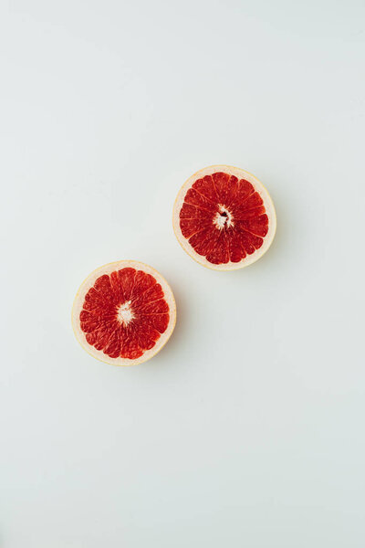 top view of juicy grapefruit halves, on grey