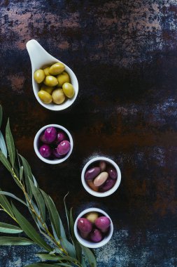 top view of ingredients for olive oil and twigs on shabby surface  clipart