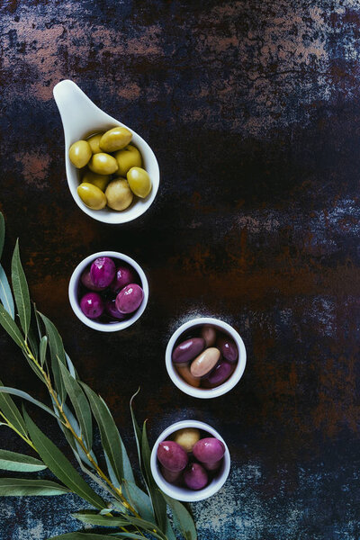 top view of ingredients for olive oil and twigs on shabby surface 