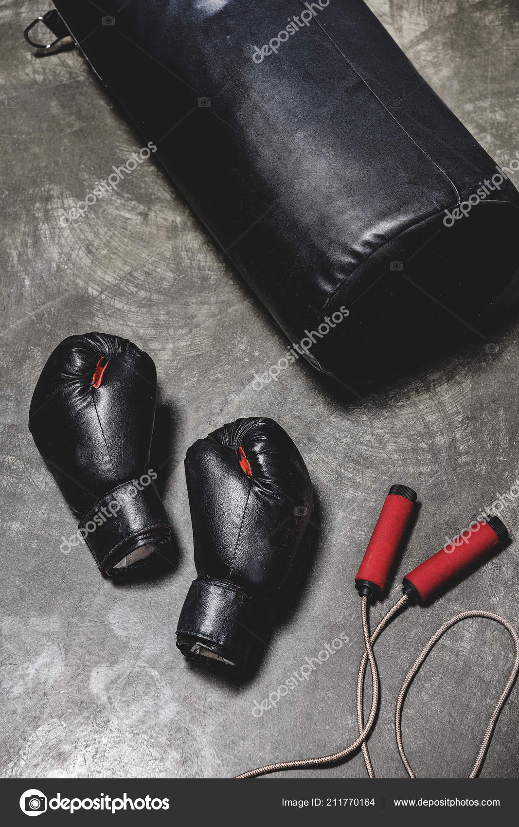 Punching Bag Jumping Rope Boxing Gloves Concrete Surface Stock Photo by