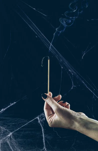 Partial view of gloomy woman holding big match with smoke in darkness with spider web — Stock Image Partial View Gloomy Woman Holding Big Match Smoke Darkness Spider Royalty Free Stock Images