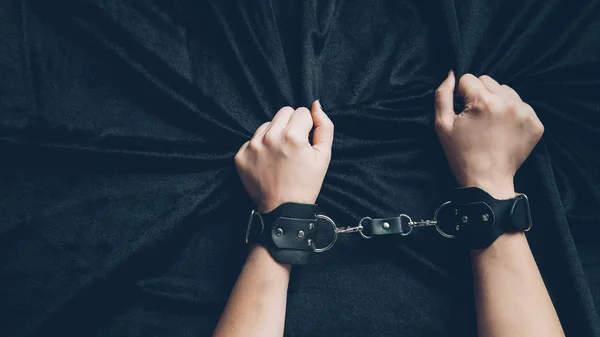 Partial View Woman Leather Handcuffs Holding Black Fabric — Stock Photo, Image