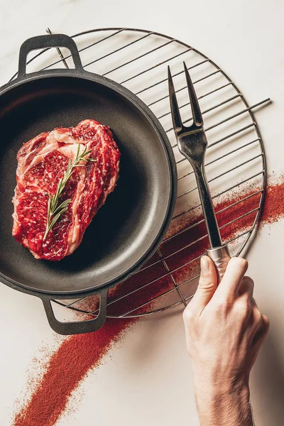 Cropped Image Man Holding Meat Fork Cooking Steak Rosemary Kitchen — Stock Photo, Image