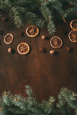top view of christmas spices on wooden background with fir branches and copy space clipart