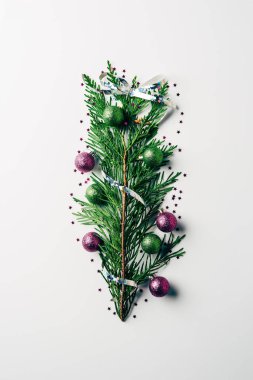 top view of green pine branch decorated with christmas toys as christmas tree on white backdrop clipart