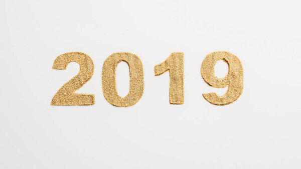 top view of 2019 year sign made of golden glitters isolated on white 