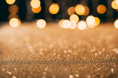 golden sparkling sequins with bokeh on background, christmas concept clipart