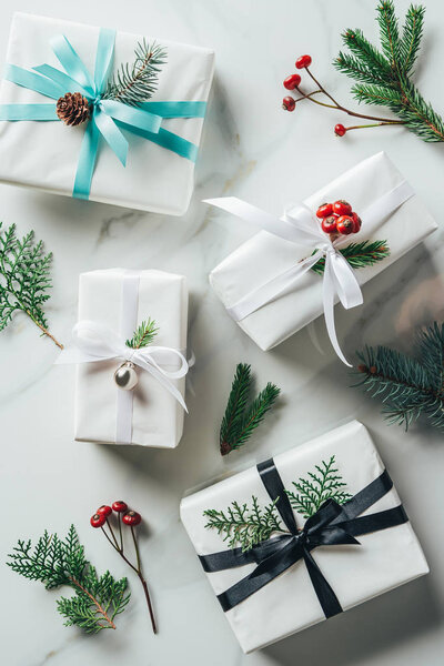 top view of white christmas presents with decoration on marble table