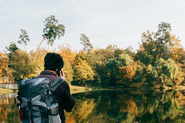 male traveller with backpack on autumnal background