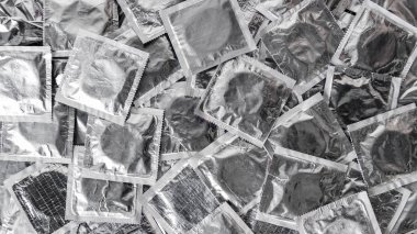 top view of pile of silver condoms   clipart