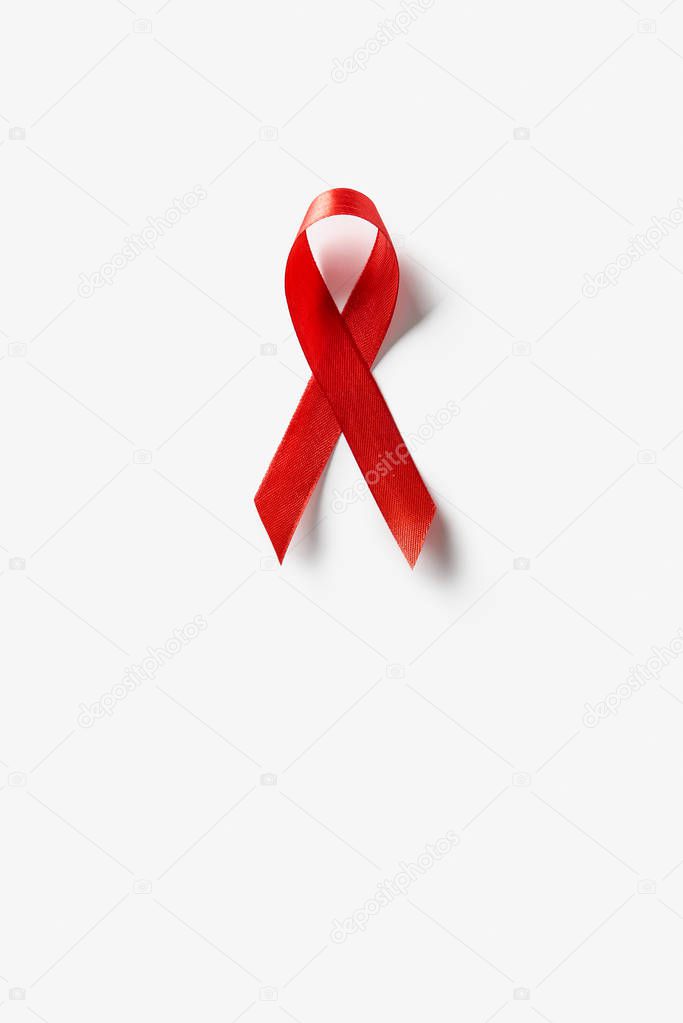 top view of aids awareness red ribbon on white background