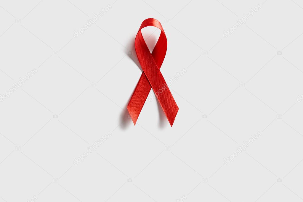 top view of aids awareness red ribbon on white background