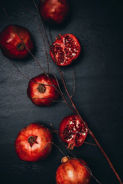 Top View Ripe Pomegranates Twig Arrangement Black Surface — Free Stock Photo