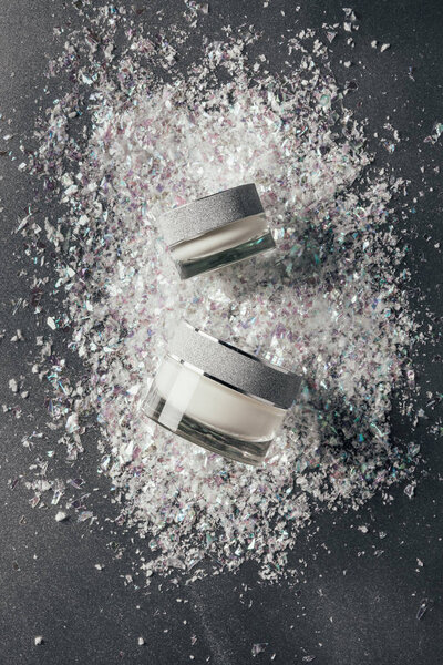 elevated view of beauty cream with decoration shavings on silver
