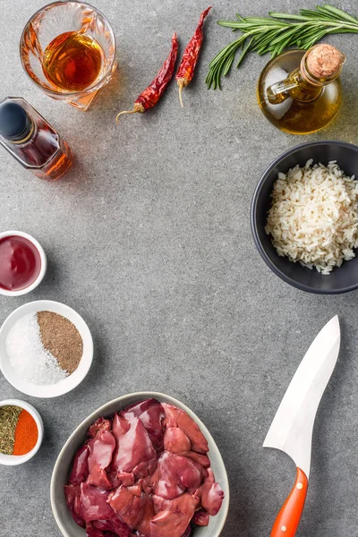 Top View Raw Meat Rice Spices Oil Cognac Peppers Knife — Stock Photo, Image