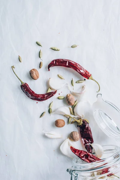 Top view of jar and different spices on white table — Stock Photo