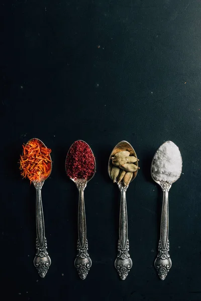 Top view of salt, saffron and chili pepper spices on table — Stock Photo