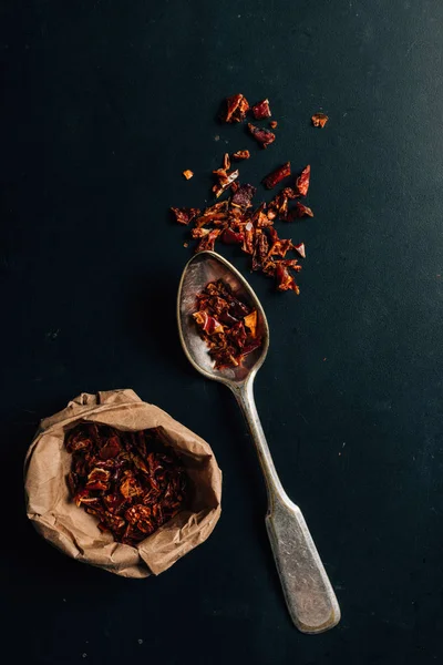 Top view of dried red chili pepper on dark table — Stock Photo