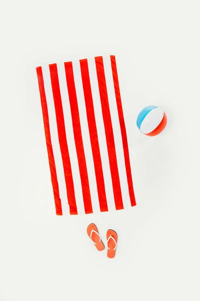 Top view of striped beach towel, flip flops and inflatable beach ball isolated on white — Stock Photo