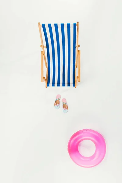 Top view of striped beach chair, flip flops and inflatable ring isolated on white — Stock Photo