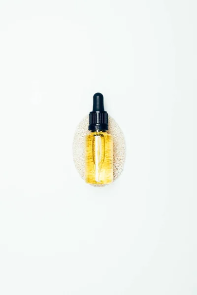 Top view of cosmetic bottle with pipe and sponge isolated on white surface — Stock Photo