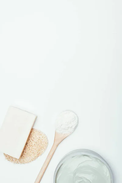 Flat lay with soap, sponge, spoon, clay mask in container and clay powder isolated on white surface — Stock Photo