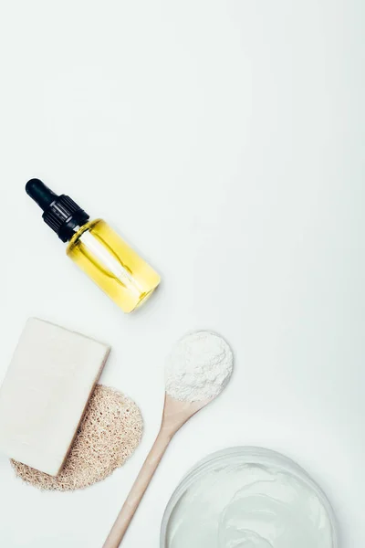 Top view of soap, sponge, spoon, clay mask in container and clay powder isolated on white surface — Stock Photo