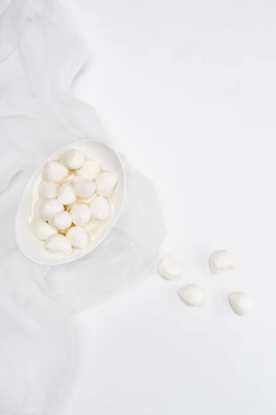 Top view of mozzarella cheese curds on white surface — Stock Photo