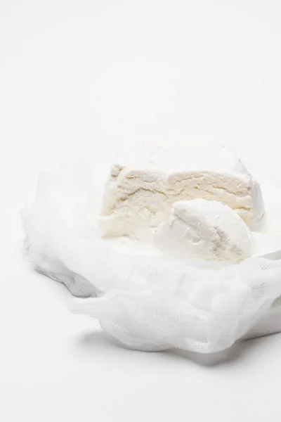 Delicious cottage cheese on cheesecloth with spoon on white tabletop — Stock Photo