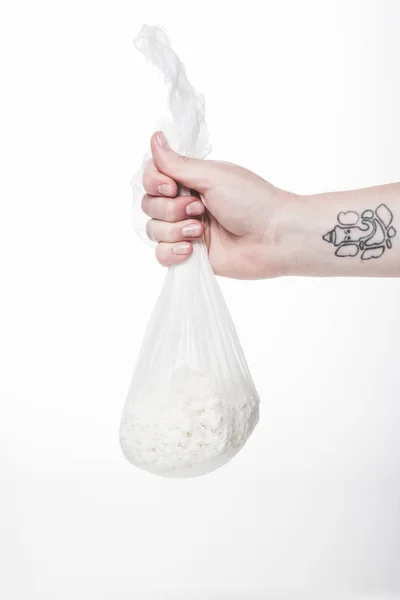 Cropped shot of woman holding cheesecloth sack with cottage cheese isolated on white — Stock Photo