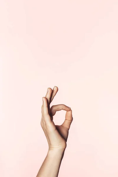 Cropped shot of woman doing ok gesture by hand isolated on pink background — Stock Photo