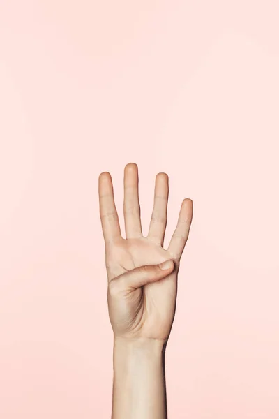 Cropped shot of woman counting from one to four by hand isolated on pink background — Stock Photo