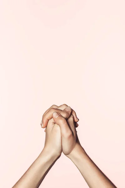 Cropped shot of woman holding own hands together isolated on pink background — Stock Photo