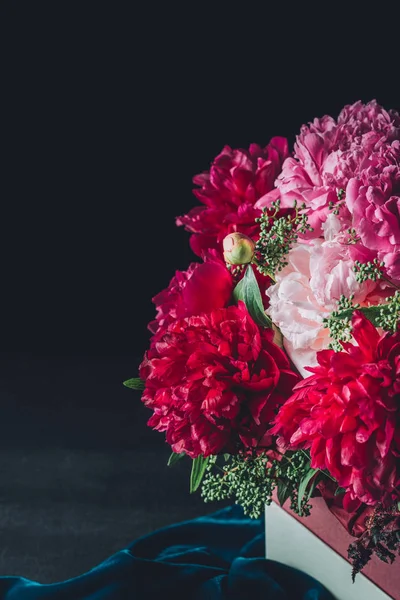 Beautiful pink peony bouquet on dark cloth — Stock Photo