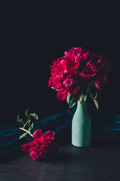 Festive bouquet of pink peonies in vase on dark background — Stock Photo