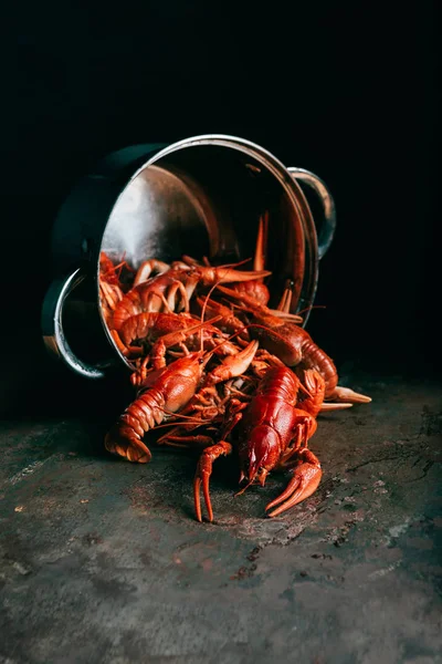Closeup view of saucepan with pile of crayfishes on rustic tabletop — Stock Photo