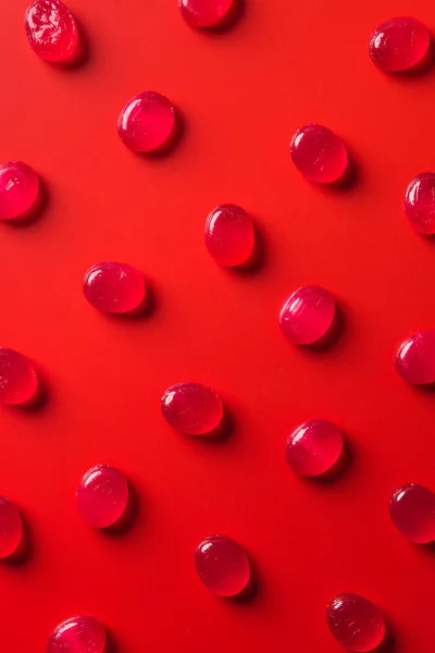 Top view of collection of candies on red surface — Stock Photo