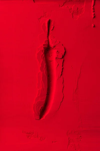 Top view of chili pepper shape on red powder — Stock Photo