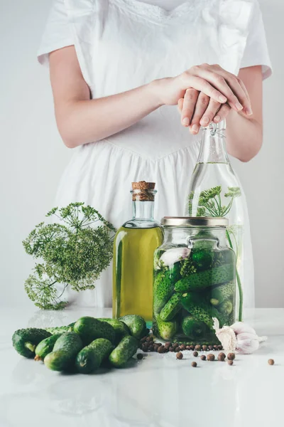 Cropped image of woman preparing preserved cucumbers at kitchen — Stock Photo